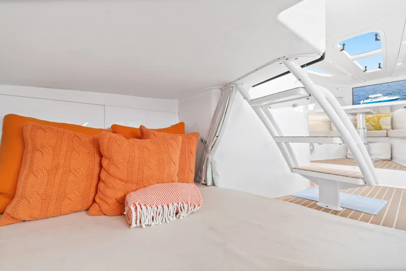  Yacht Photos Pics Cozy interior of 2018 Intrepid 407 Cuddy with orange pillows and modern design.