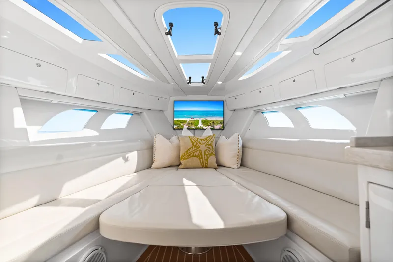  Yacht Photos Pics Luxurious interior of 2018 Intrepid 407 Cuddy boat with plush seating and scenic view.