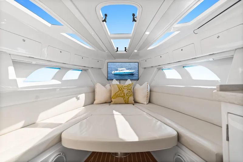  Yacht Photos Pics Luxurious interior of 2018 Intrepid 407 Cuddy boat with plush seating and skylights.