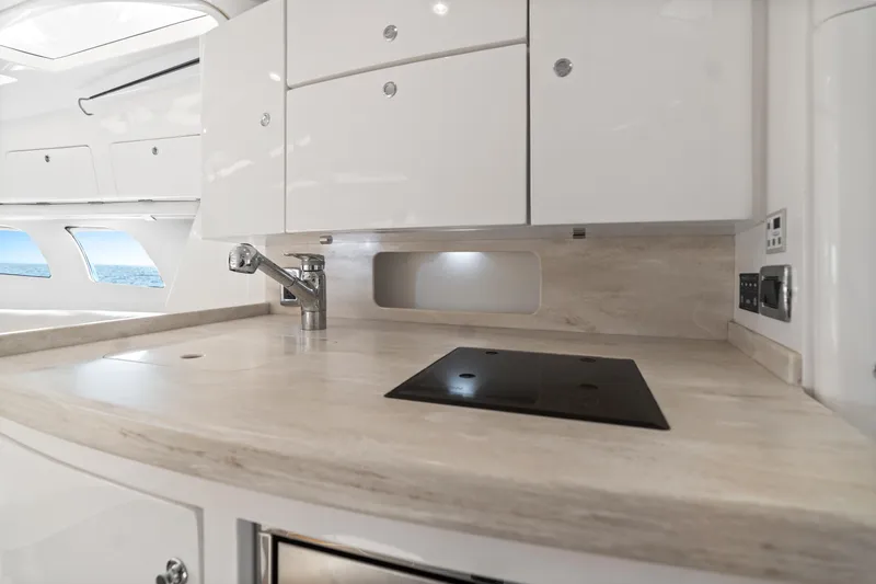  Yacht Photos Pics 2018 Intrepid 407 Cuddy interior kitchen with sleek countertops and modern fixtures.