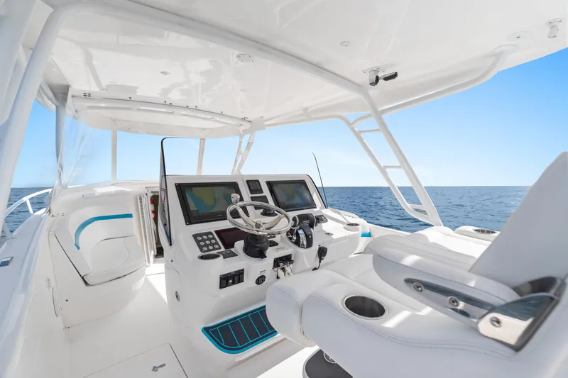  Yacht Photos Pics 2018 Intrepid 407 Cuddy boat helm with dual screens, steering wheel, and ocean view.