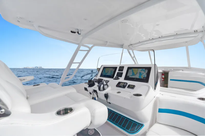  Yacht Photos Pics 2018 Intrepid 407 Cuddy boat interior with navigation screens and ocean view.