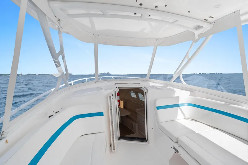 Yacht Photos Pics 2018 Intrepid 407 Cuddy boat interior with open cabin, on calm ocean waters.