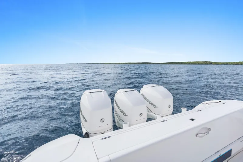  Yacht Photos Pics 2018 Intrepid 407 Cuddy boat with triple Mercury engines on open water.