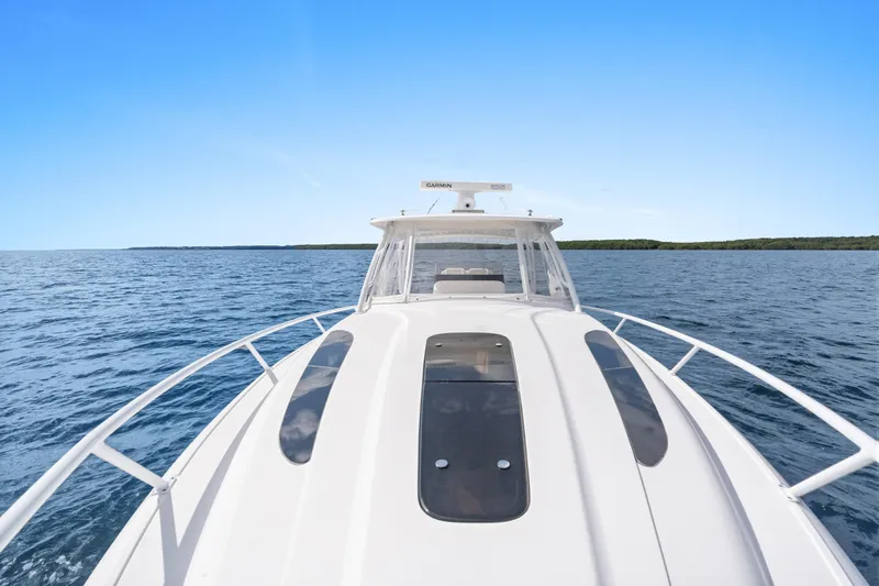  Yacht Photos Pics 2018 Intrepid 407 Cuddy cruising on open water under clear blue sky.