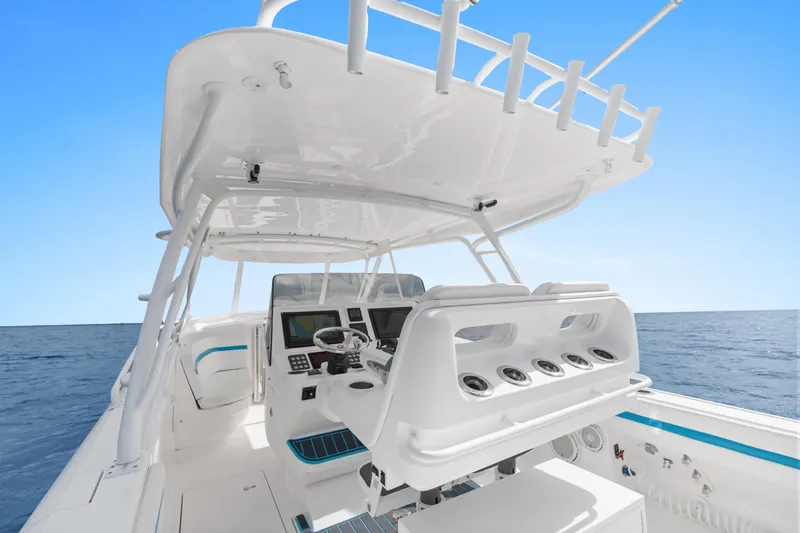  Yacht Photos Pics 2018 Intrepid 407 Cuddy boat interior with helm, ocean view, and clear blue sky.