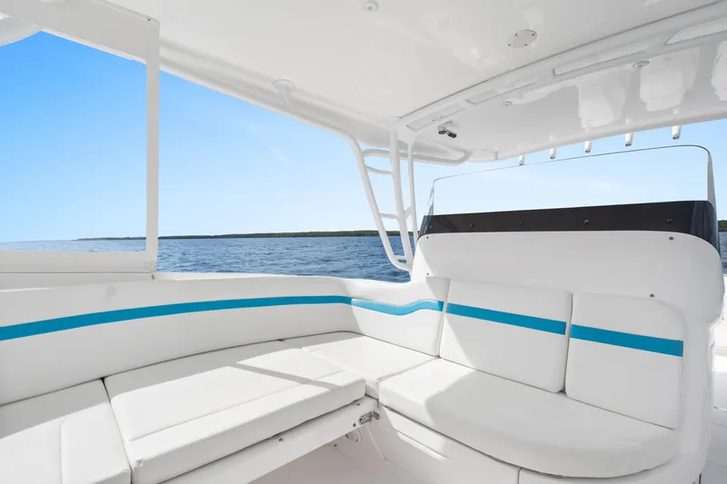 Yacht Photos Pics 2018 Intrepid 407 Cuddy boat interior with white seating and blue accents, ocean view.