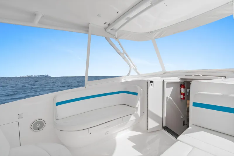  Yacht Photos Pics 2018 Intrepid 407 Cuddy boat interior with ocean view and seating area.