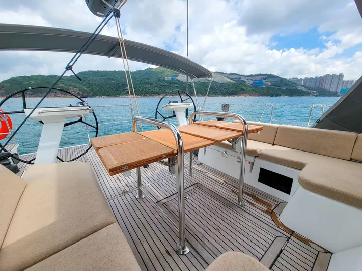  Yacht Photos Pics Luxurious 2023 Beneteau First 53 yacht deck with seating and scenic ocean view.