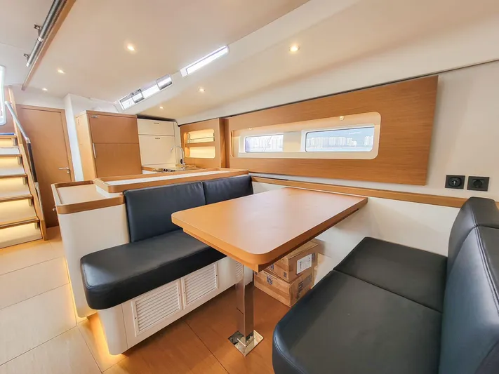  Yacht Photos Pics Luxurious interior of 2023 Beneteau First 53 yacht with modern seating and dining area.