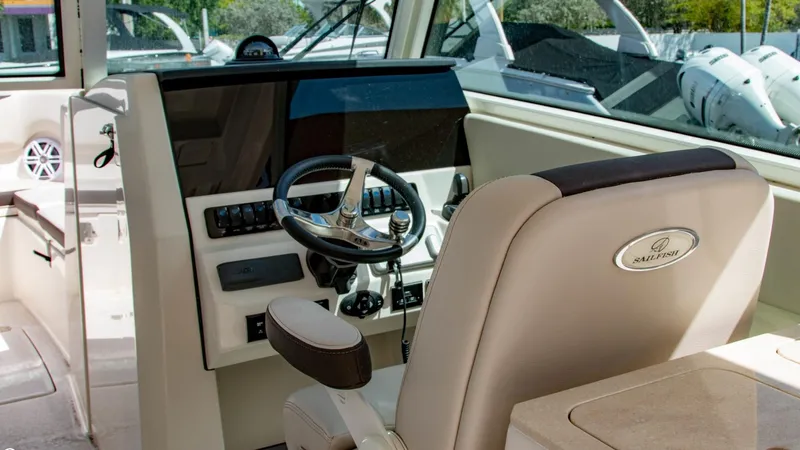  Yacht Photos Pics 2023 Sailfish 316 DC boat helm with steering wheel and control panel.