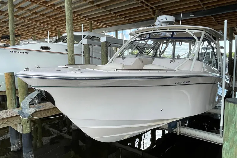  Yacht Photos Pics 2014 Grady-White Freedom 335 boat docked under a wooden canopy.