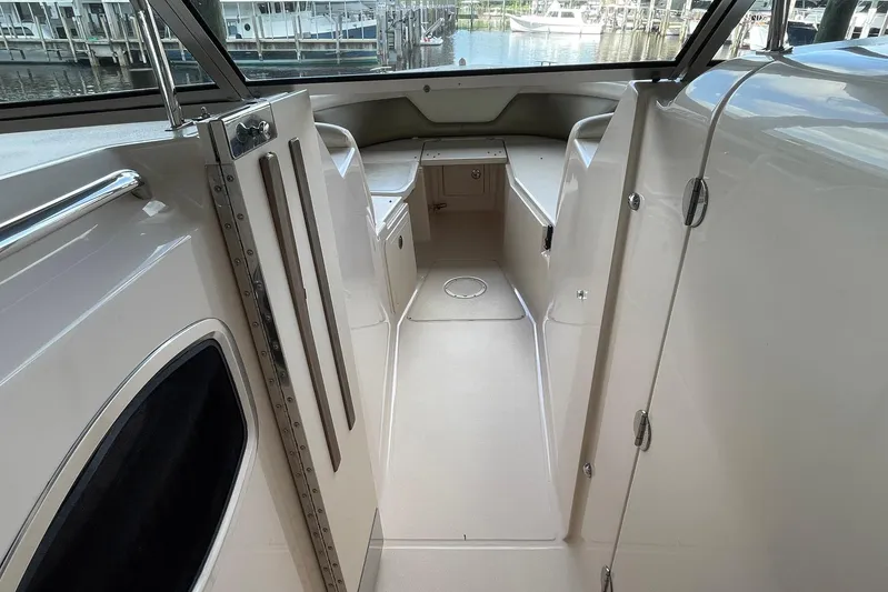  Yacht Photos Pics 2014 Grady-White Freedom 335 boat interior with seating and storage compartments.