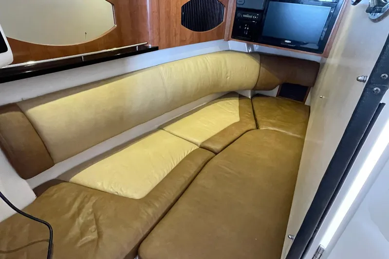  Yacht Photos Pics 2014 Grady-White Freedom 335 cabin interior with beige seating and wooden accents.