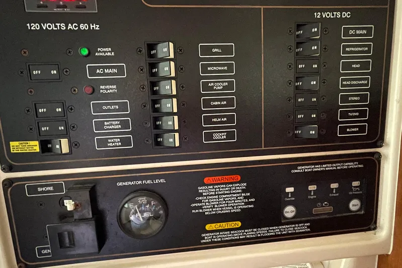  Yacht Photos Pics Electrical control panel on a 2014 Grady-White Freedom 335 boat, showing switches and warnings.