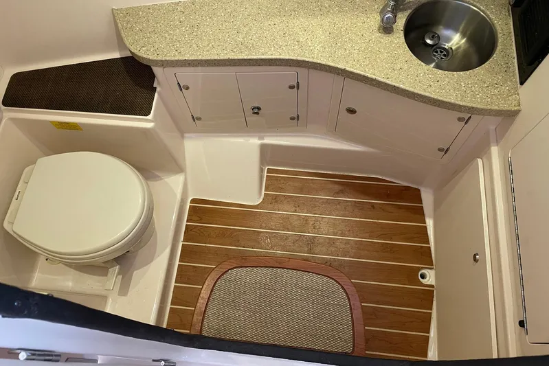  Yacht Photos Pics 2014 Grady-White Freedom 335 boat bathroom with wooden floor, sink, and toilet.