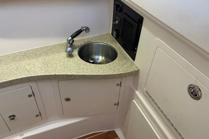  Yacht Photos Pics 2014 Grady-White Freedom 335 boat interior with sink and storage compartments.