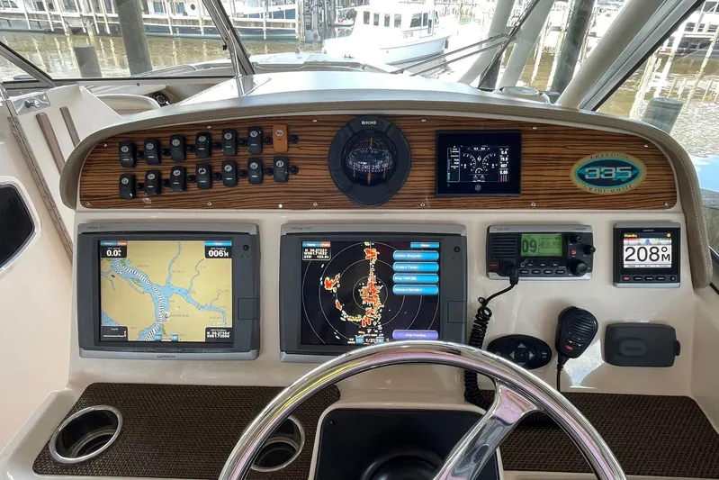  Yacht Photos Pics Control panel of a 2014 Grady-White Freedom 335 boat with navigation screens.