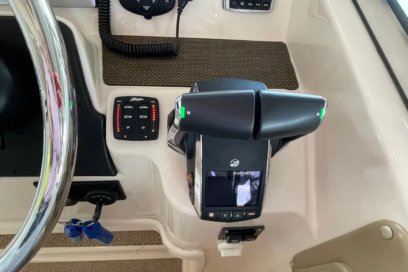  Yacht Photos Pics Control panel of 2014 Grady-White Freedom 335 boat with steering wheel and throttle levers.