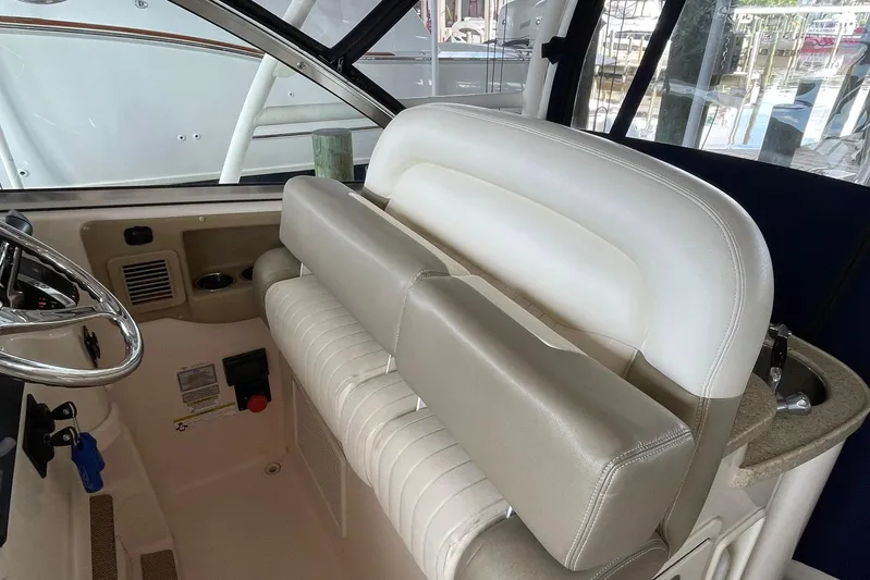  Yacht Photos Pics 2014 Grady-White Freedom 335 boat interior with steering wheel and seating area.