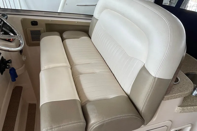  Yacht Photos Pics 2014 Grady-White Freedom 335 boat interior with plush seating and steering wheel.