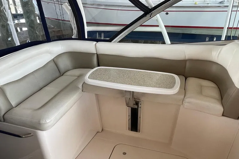  Yacht Photos Pics 2014 Grady-White Freedom 335 boat interior with cushioned seating and table.