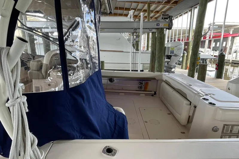  Yacht Photos Pics 2014 Grady-White Freedom 335 boat interior with seating and protective cover.