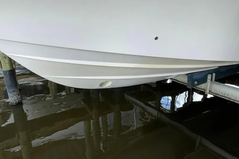  Yacht Photos Pics 2014 Grady-White Freedom 335 boat hull in docked position, reflecting on water.