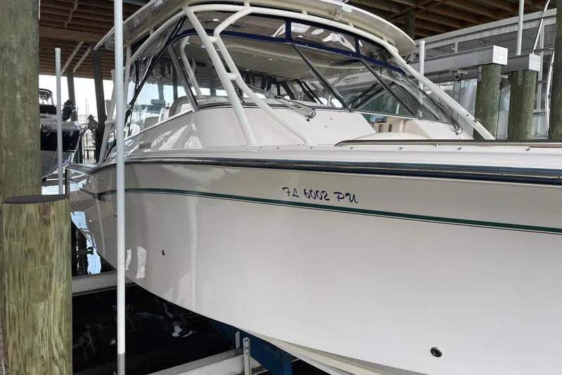  Yacht Photos Pics 2014 Grady-White Freedom 335 boat docked in a marina, side view.