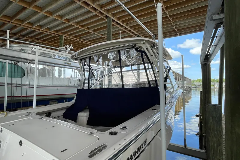  Yacht Photos Pics 2014 Grady-White Freedom 335 boat docked under a covered marina.