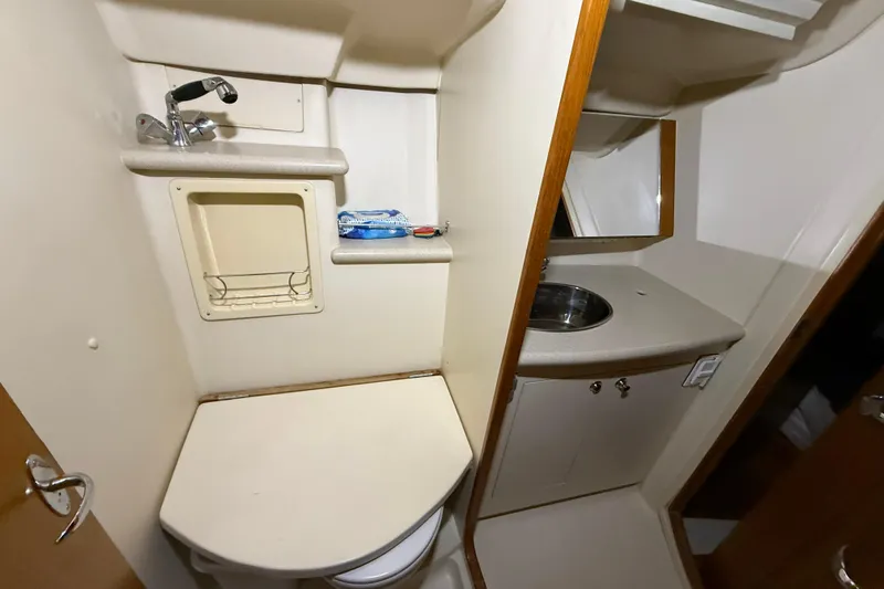 Wind D Yacht Photos Pics Compact bathroom in 2005 Hunter 46LE yacht with sink, mirror, and toilet.