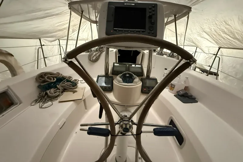 Wind D Yacht Photos Pics Interior view of 2005 Hunter 46LE sailboat cockpit with steering wheel and navigation equipment.