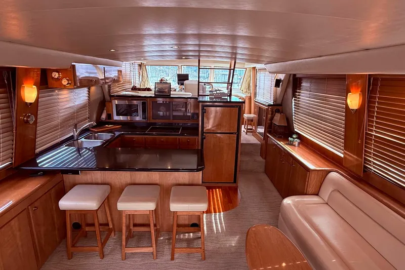  Yacht Photos Pics Luxurious 2007 Navigator 51 yacht interior with modern kitchen and elegant seating area.