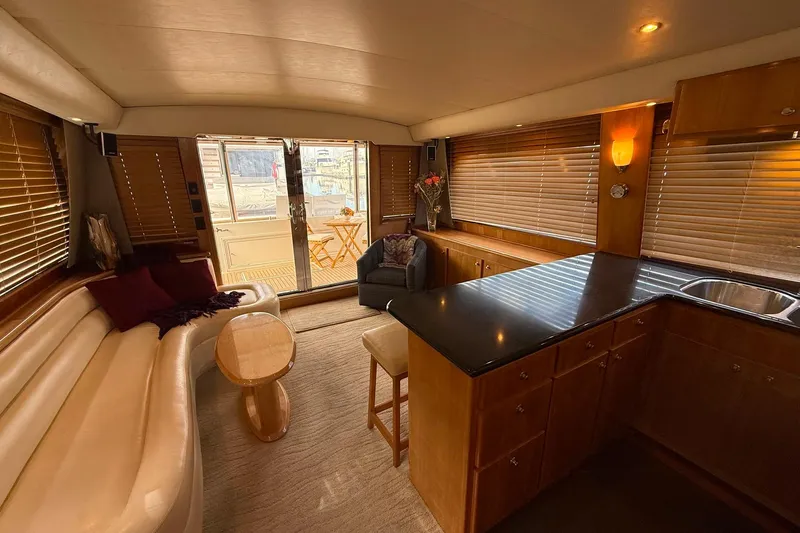  Yacht Photos Pics Luxurious interior of a 2007 Navigator 51 yacht with elegant seating and wooden cabinetry.