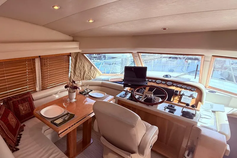  Yacht Photos Pics Luxurious 2007 Navigator 51 yacht interior with dining area and helm station.