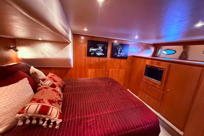  Yacht Photos Pics Luxurious bedroom interior of 2007 Navigator 51 yacht with elegant decor and ambient lighting.