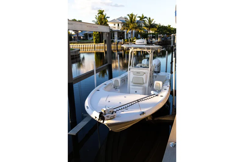  Yacht Photos Pics 2022 Caymas 28 HB Twin boat docked in a serene marina setting.