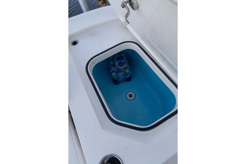  Yacht Photos Pics Storage compartment on 2022 Caymas 28 HB Twin boat with water bottles inside.