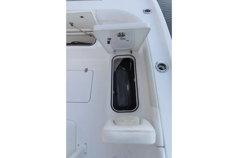  Yacht Photos Pics 2022 Caymas 28 HB Twin boat storage compartment with open hatch and cushioned seat.