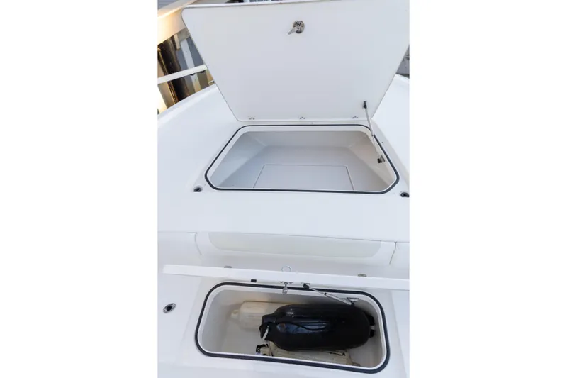  Yacht Photos Pics 2022 Caymas 28 HB Twin boat storage compartments, open and empty, showcasing interior space.
