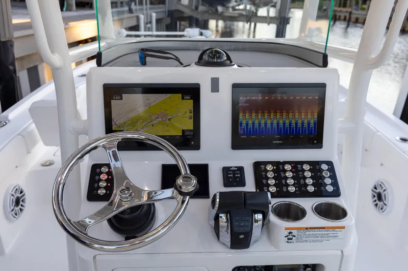  Yacht Photos Pics 2022 Caymas 28 HB Twin boat dashboard with dual Garmin displays and steering wheel.