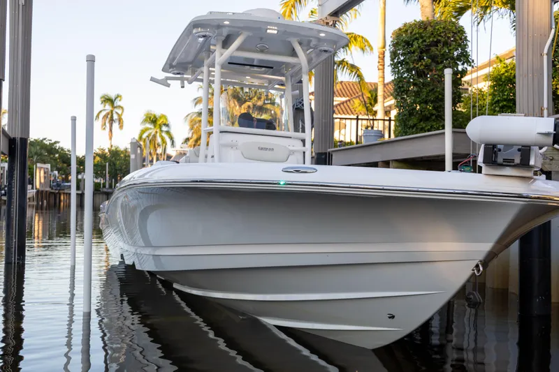  Yacht Photos Pics 2022 Caymas 28 HB Twin boat docked near palm trees.
