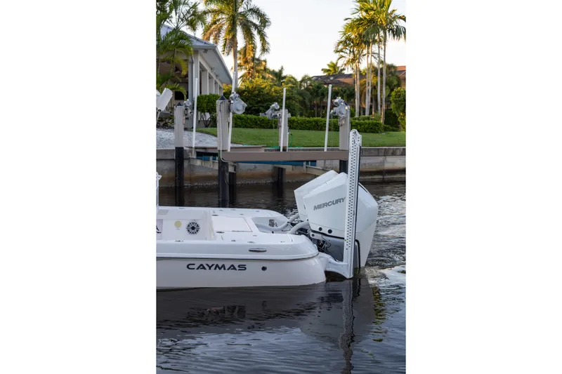  Yacht Photos Pics 2022 Caymas 28 HB Twin boat docked with Mercury engines, surrounded by tropical scenery.