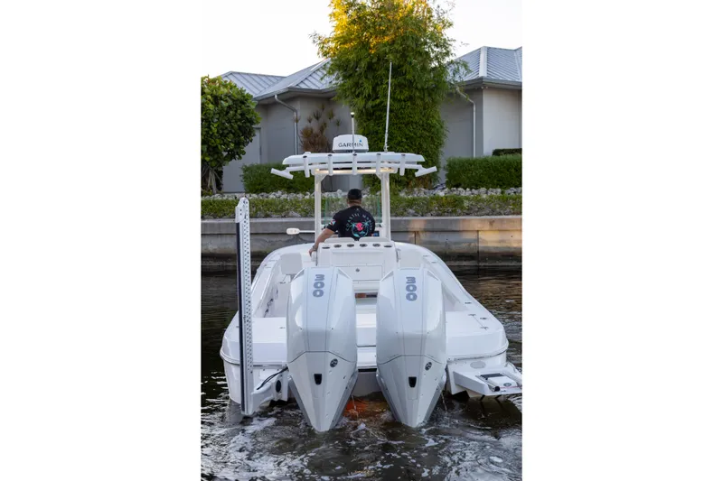  Yacht Photos Pics 2022 Caymas 28 HB Twin boat with dual engines on a calm waterway.