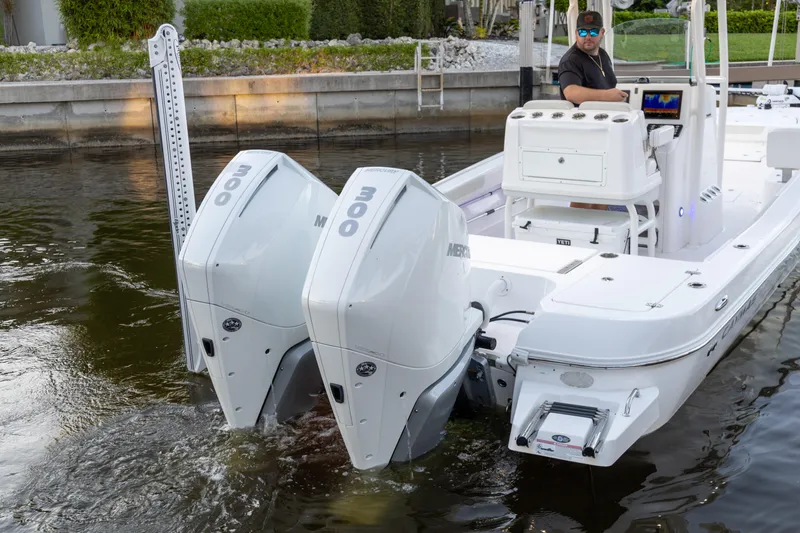  Yacht Photos Pics 2022 Caymas 28 HB Twin boat with dual Mercury 300 engines in a canal setting.