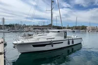 2022 Nimbus T11 boat docked in a marina under a partly cloudy sky.