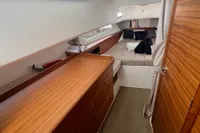 Luxurious interior of 2022 Nimbus T11 boat with wooden cabinetry and cozy sleeping area.