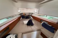 Luxurious interior cabin of 2022 Nimbus T11 boat with cozy bedding and towels.
