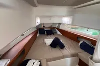 Cozy cabin interior of 2022 Nimbus T11 boat with neatly arranged bedding.