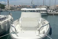 2022 Nimbus T11 boat docked in a marina, surrounded by other vessels.